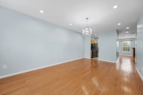 Living and dining room with hardwood floors and chandelier