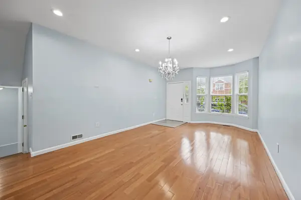 Living room with bay window, chandelier and front entry