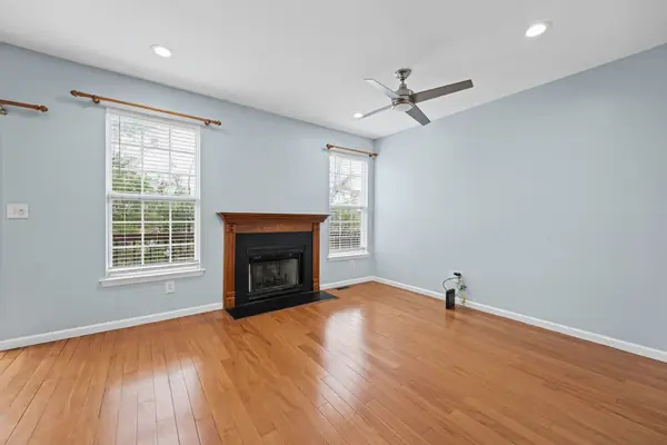 Family room with gas fireplace and ceiling fan