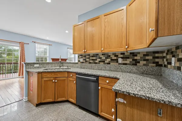 Granite kitchen counters with a view out to the deck