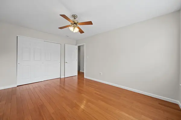 Bedroom with double closet and hardwood floors