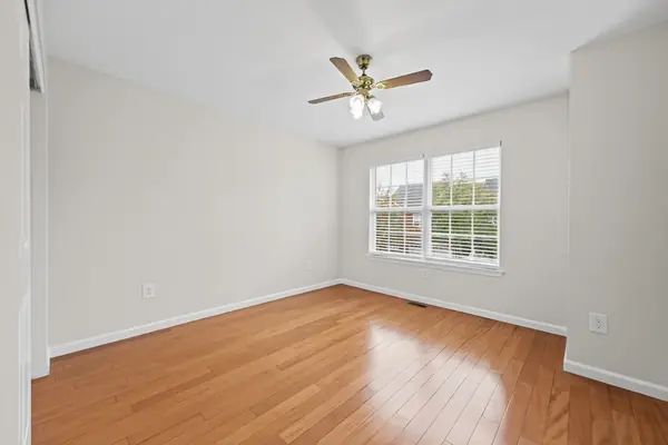 Bedroom with ceiling fan and window