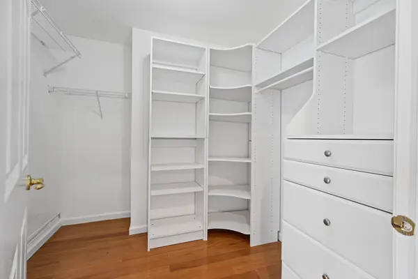 Walk-in closet with custom shelving and drawers