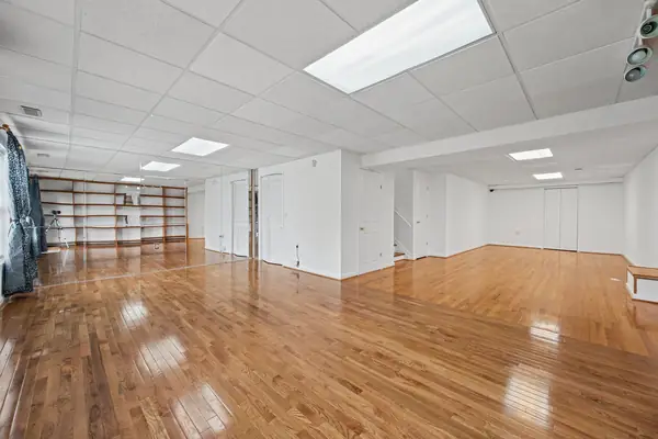 Finished basement recreation room with built-in shelving